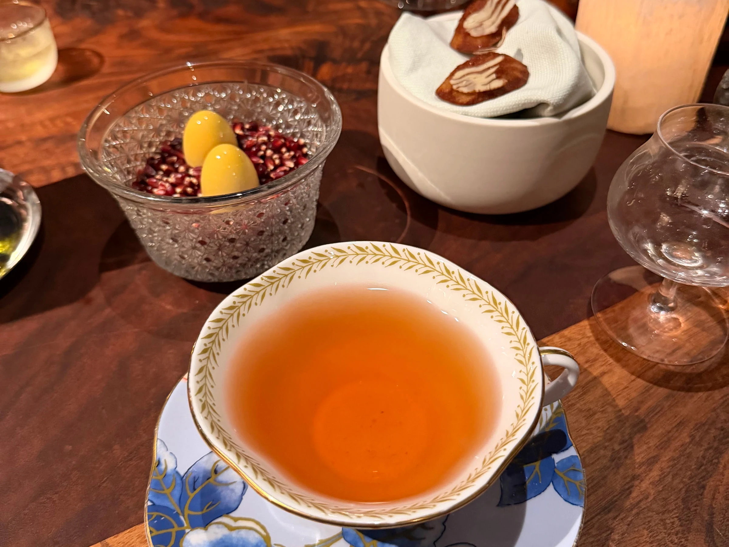 Tea service with colorful porcelain cup, confections, and petits fours at the end of a Saison meal
