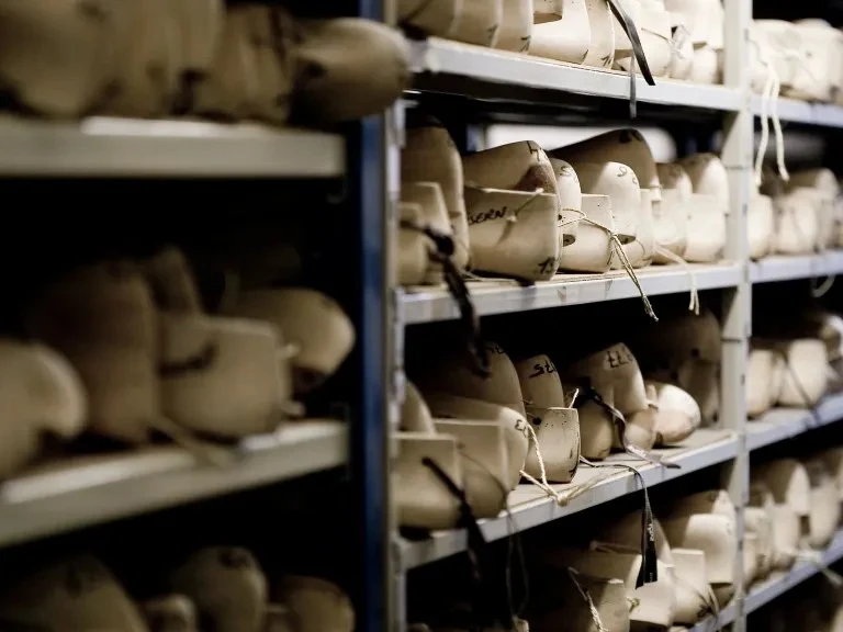 John Lobb: Rows of numbered wooden lasts on shelves.