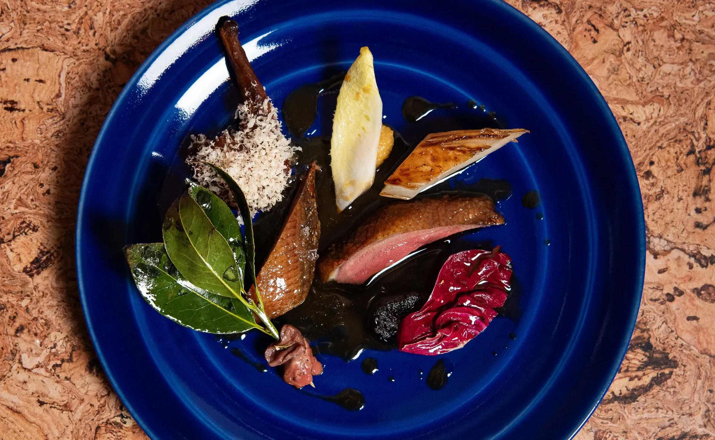 Lielle's squab course with hazelnut miso, smoked matcha butter, hen of the woods mushrooms, and black truffle jus.