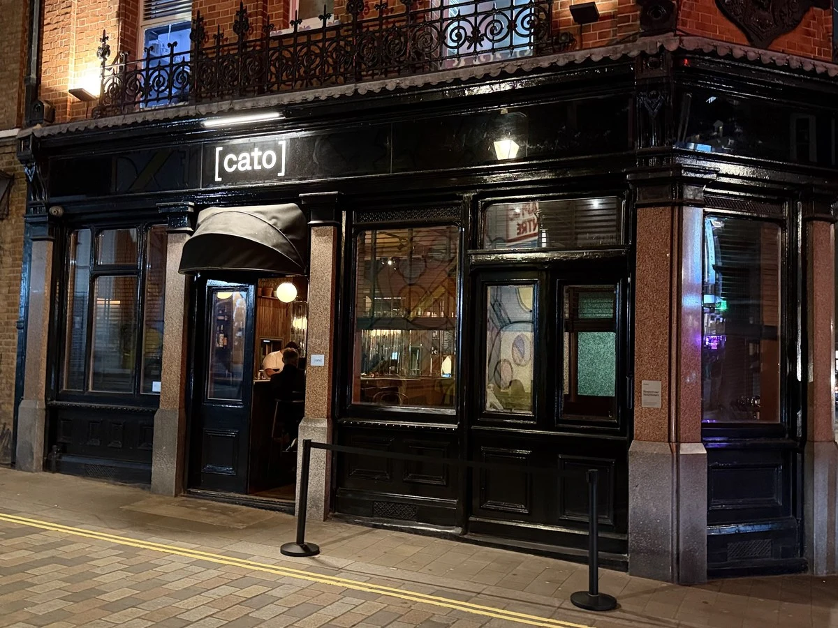Cato's inviting exterior glows at night, hinting at the culinary experience within.