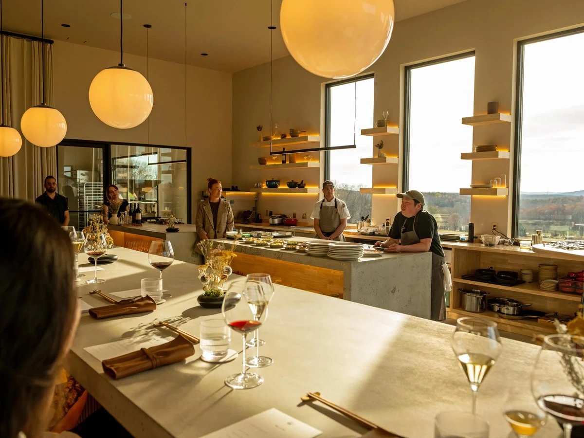 Burnt Hill Farm: A chef's counter dining room with large windows reveals a rural landscape.