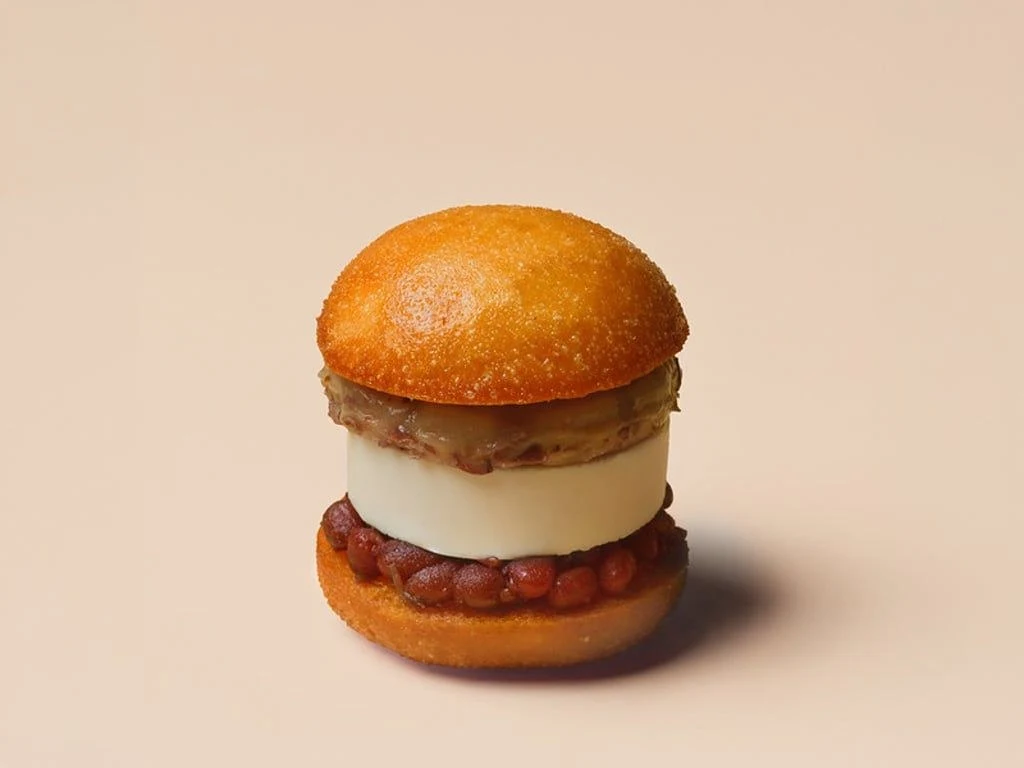 A dessert bao with a golden fried bun, salted ice cream, red beans, and mochi. source.