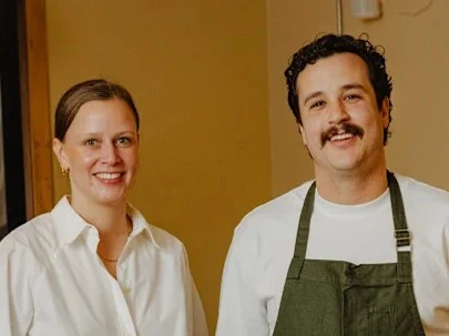 Restaurant owners/chefs in a dining room.