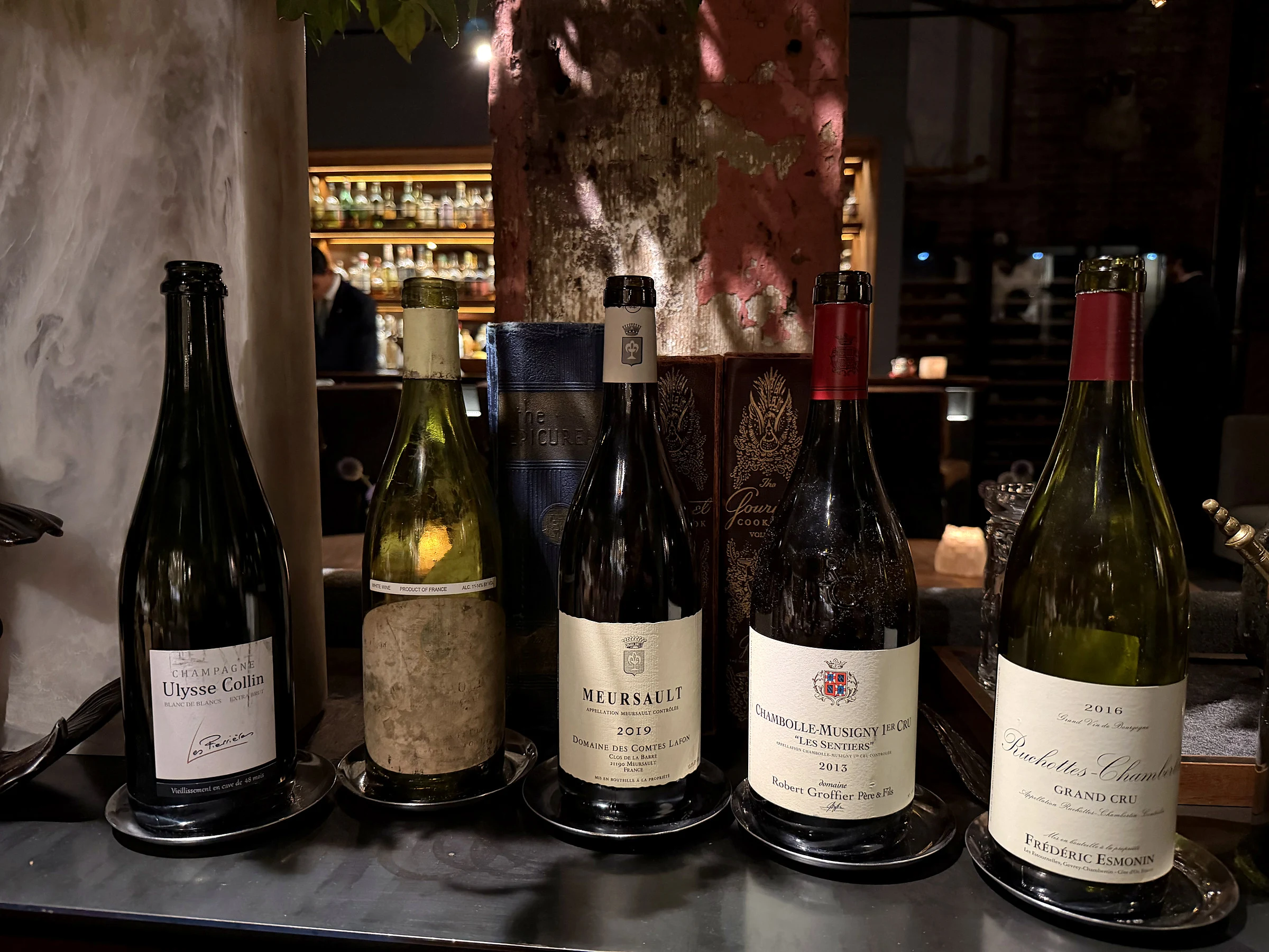 Five bottles from Saison wine service including Champagne and Burgundy