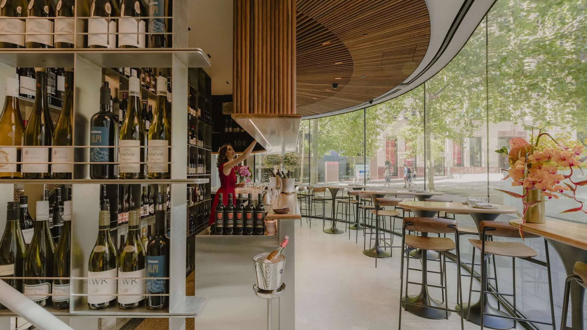 Aalia Wine Room interior with wine bottles, bar, and seating area.