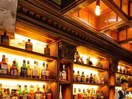The SG Club: Shingo Gokan's blueprint for a global bar program, with shelves of spirits and ornate wooden details.