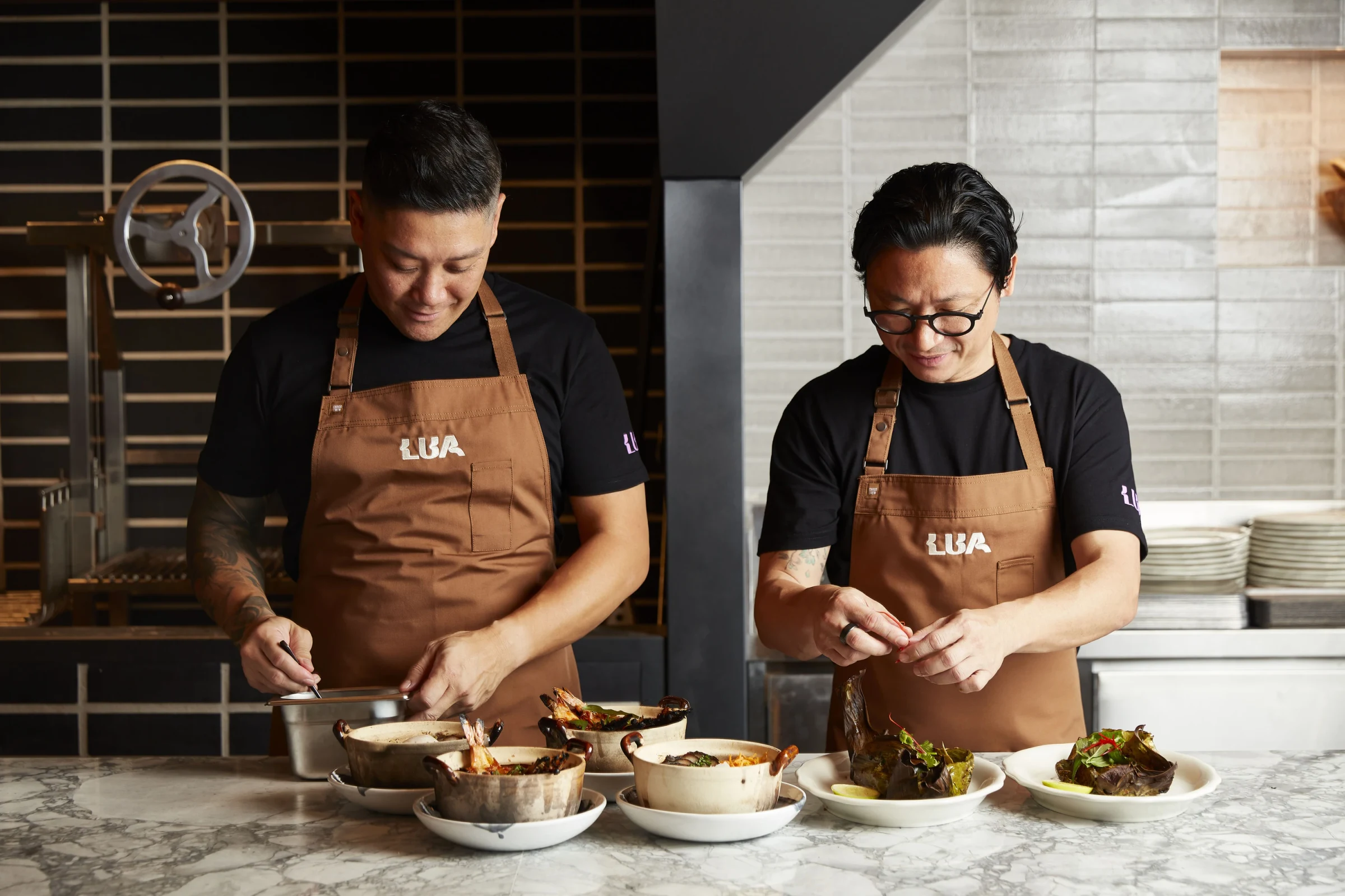 Chefs prepare dishes at lua by luke nguyen.