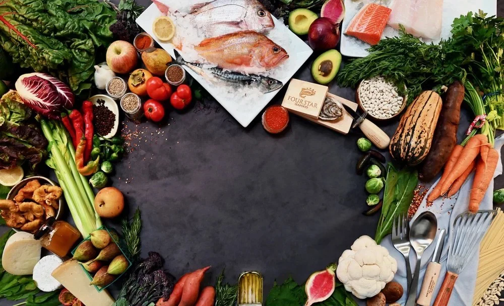 produce, pasta, seafood on ice, exotic cheeses, beautiful italian honeys, anchovies in a tin, greens galore that make you think this place has got it all when it comes to culinary offerings. these are arranged with an opening in the center to display our logo Four Star Seafood an