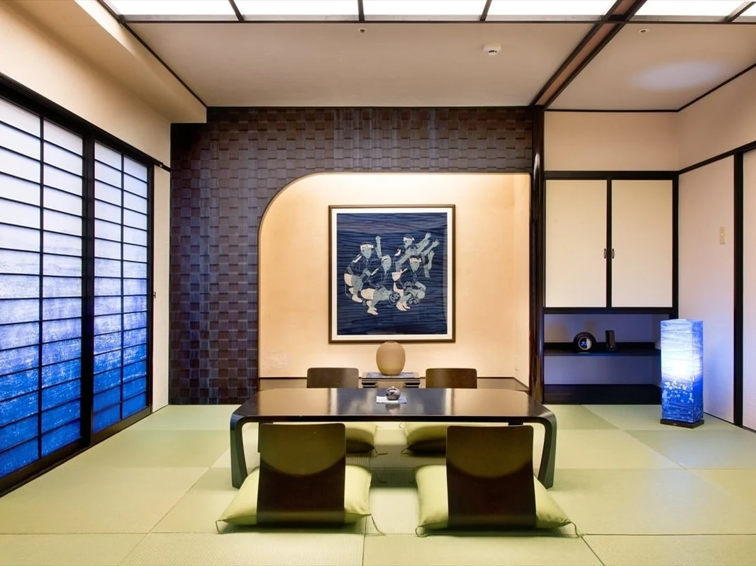 The Awa Indigo Room at AoAwo Naruto Resort, featuring an indigo-dyed textile artwork and shoji screens.