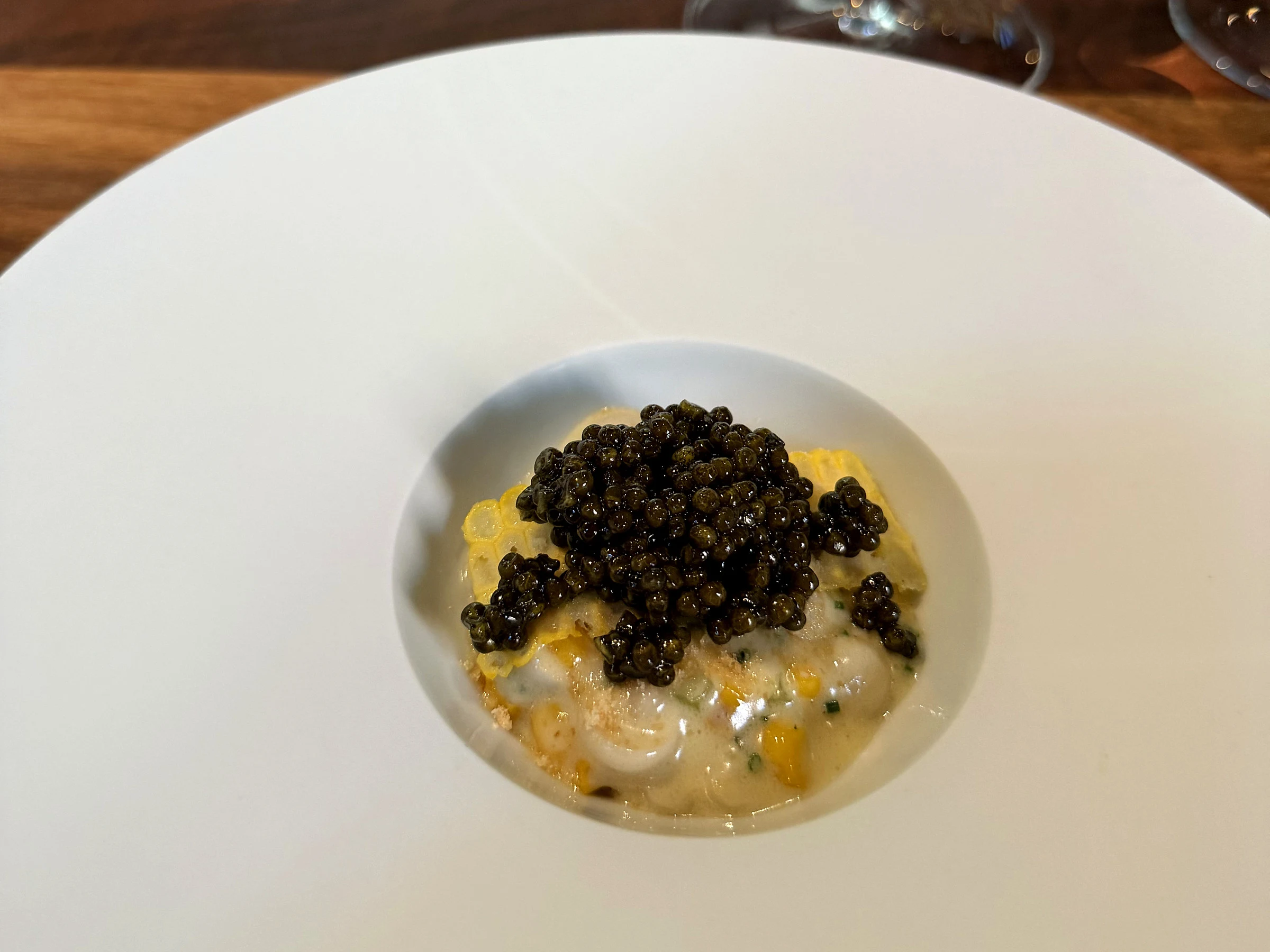 Saison caviar course served in a wide white bowl