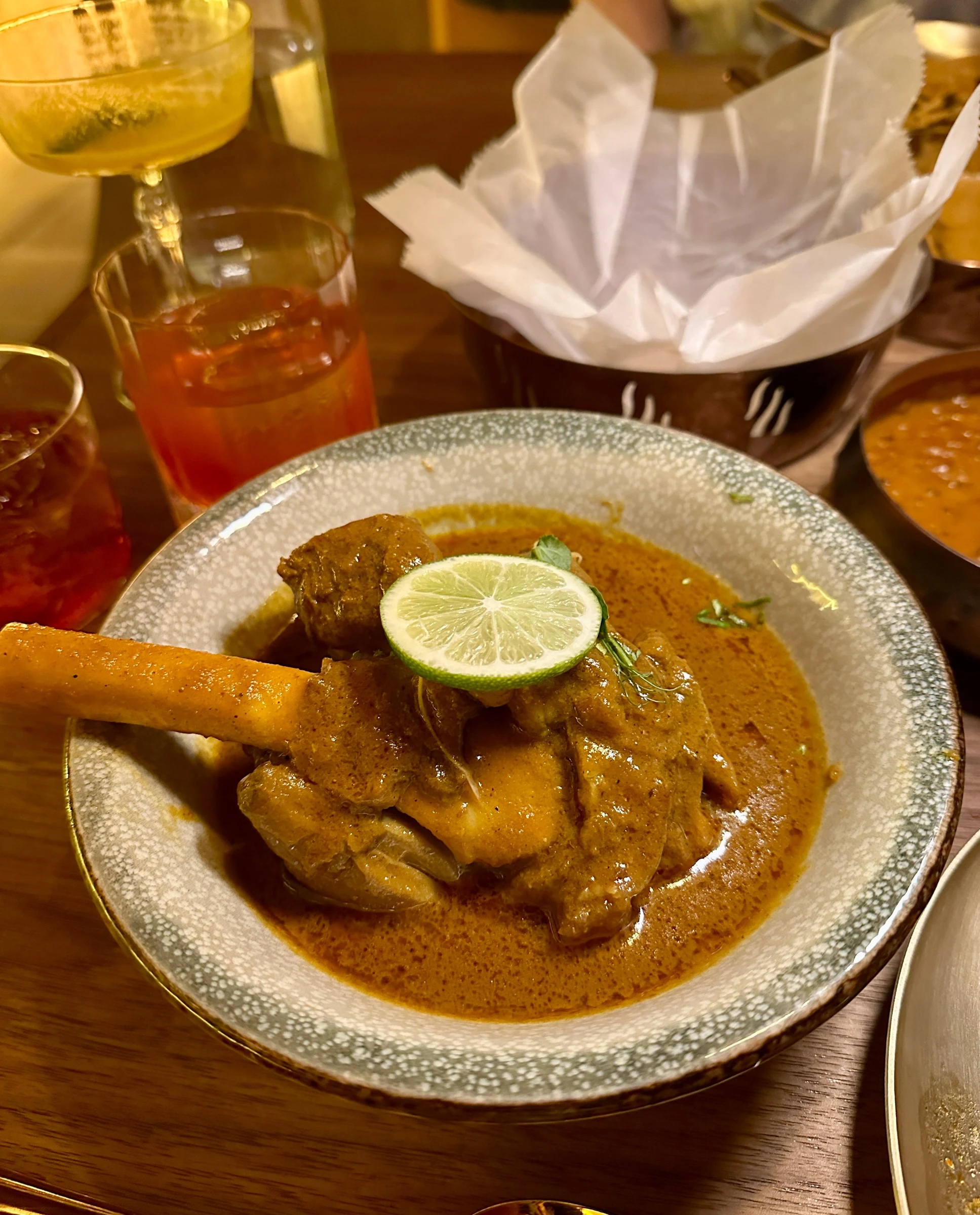 Nihari Gosht, the slow-cooked goat shank from ikara atlantic station, served in a rich curry sauce.
