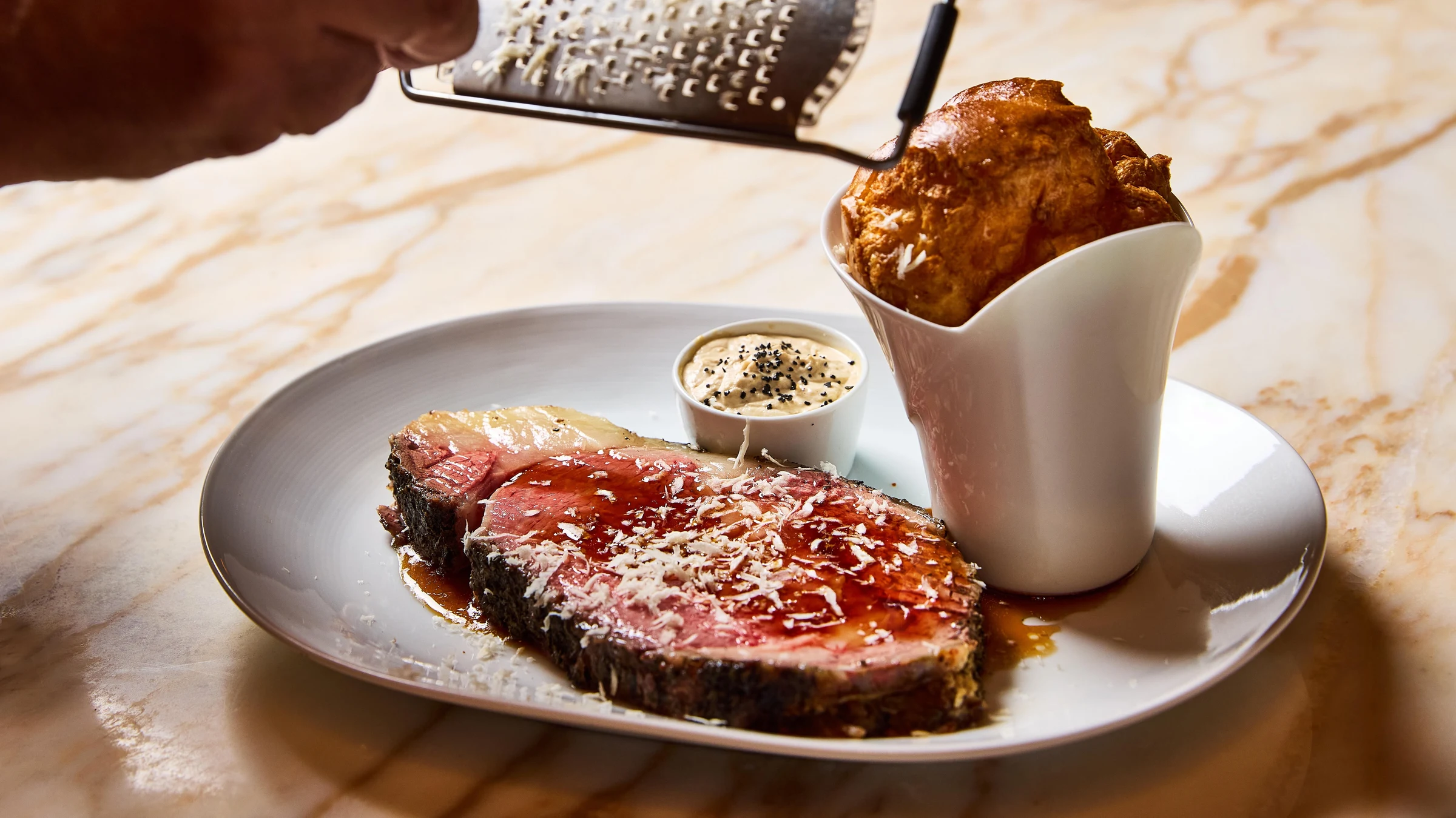 A plated prime rib steak with accompaniments at Palladino's.