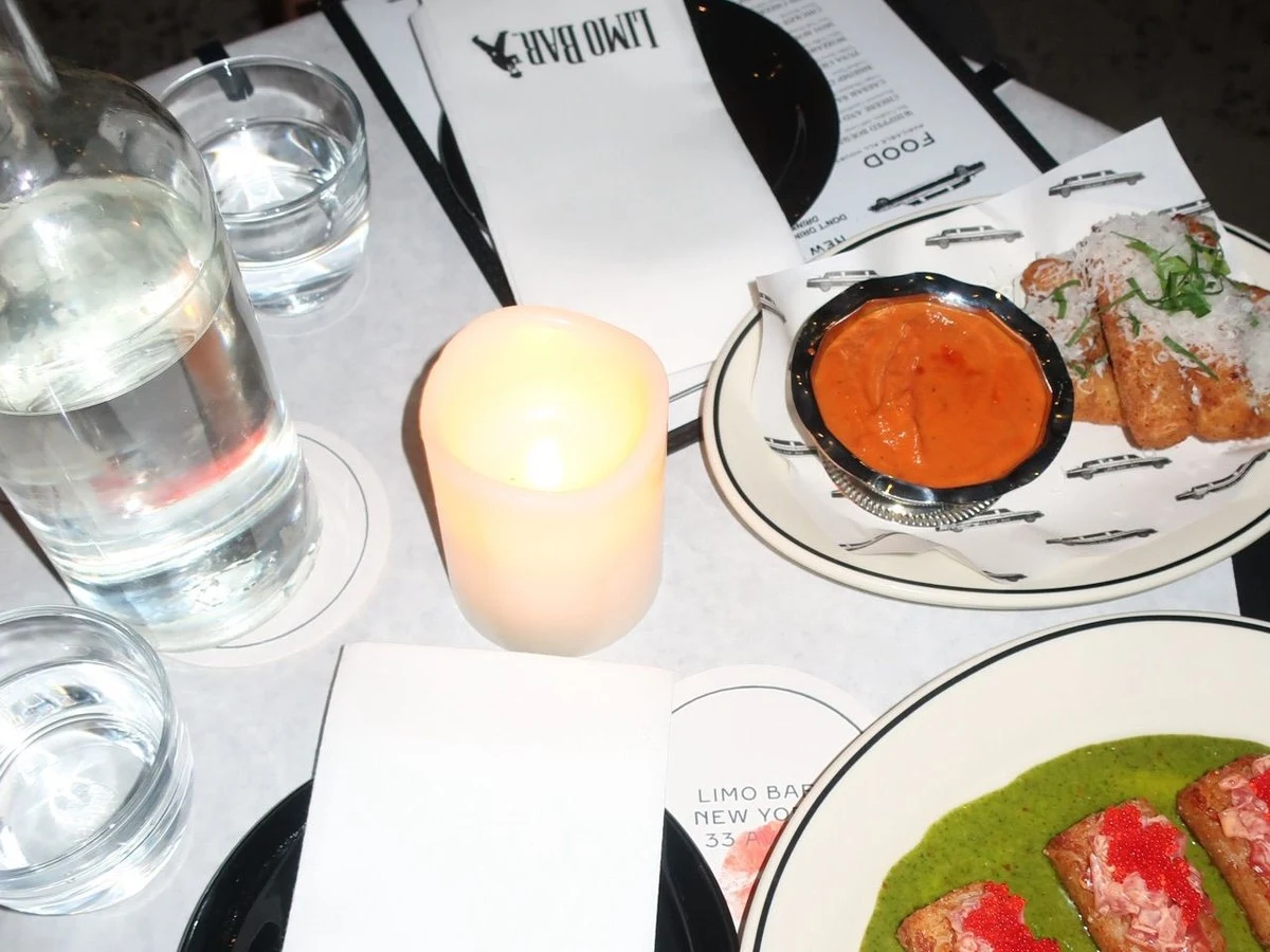 Limo Bar offers a refined dining experience with artfully presented dishes and a warm, inviting ambiance.
