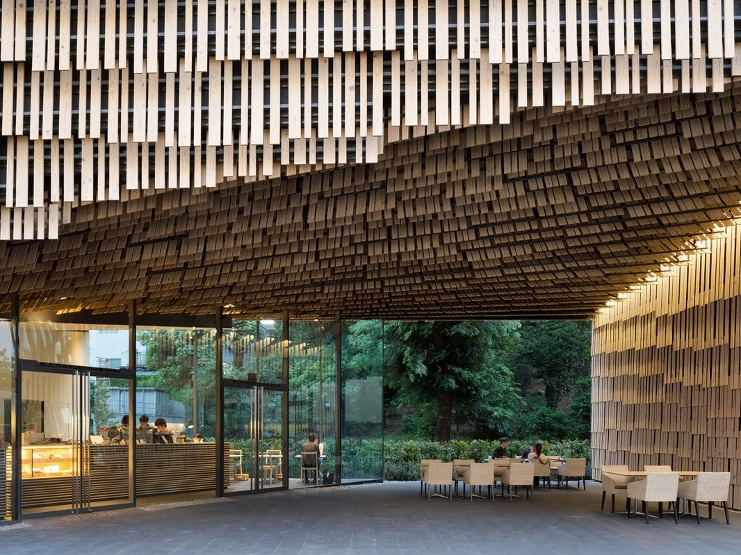 The exterior of a traditional Japanese restaurant with a wooden facade and outdoor seating.