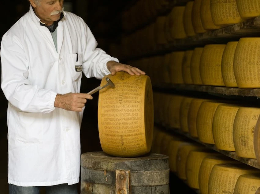 Parmigiano Reggiano dairy: An inspector taps a wheel, a key step in ensuring quality.