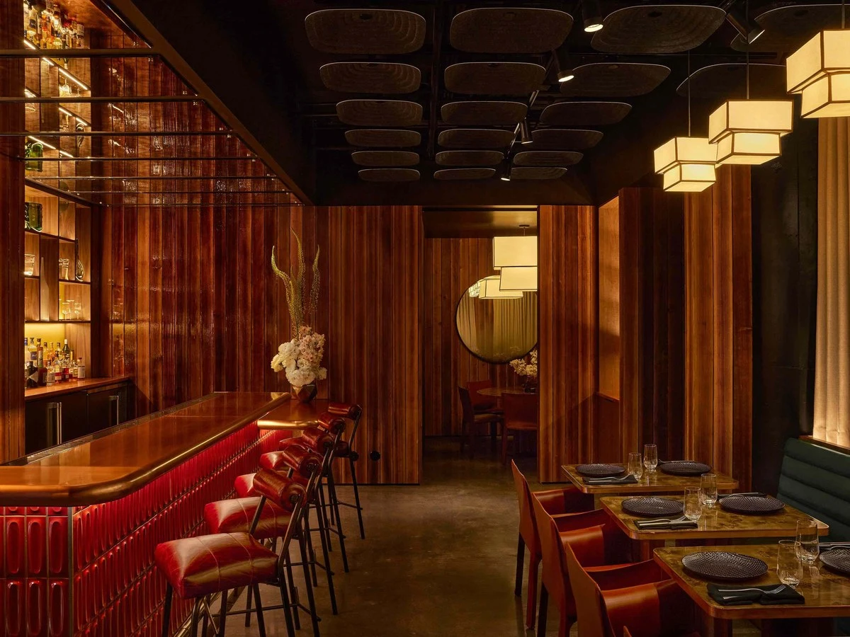 MadLab's sophisticated interior at Transamerica Pyramid, featuring rich wood, a red bar, and geometric lights.